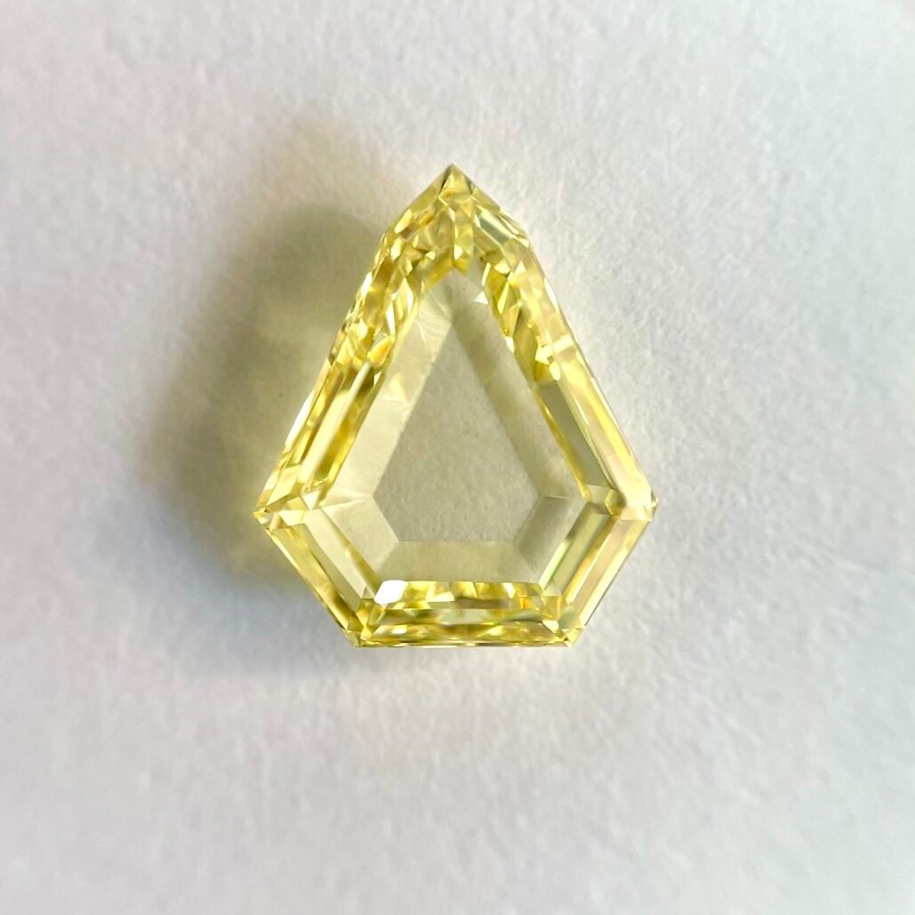 Shield Shape Fancy Yellow portrait step cut diamond